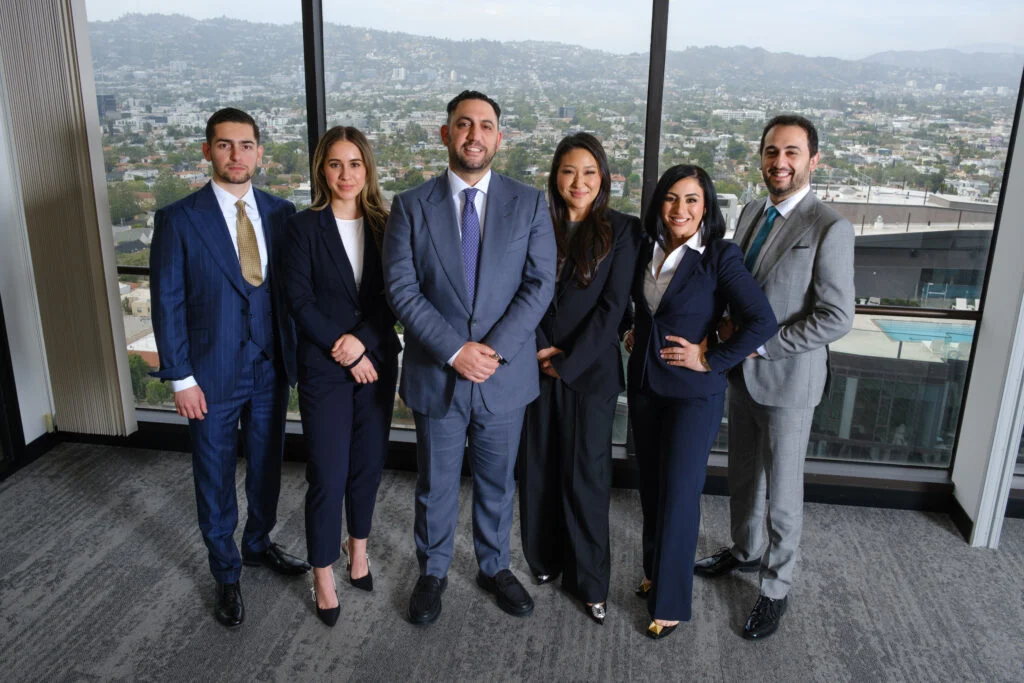 The Capital Law Firm — the team in front of a Los Angeles skyline view from the Wilshire office